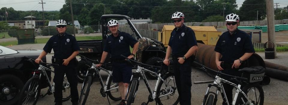 four police officers on bicycles